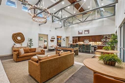 A living room with a brown couch and a wooden table.