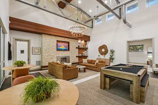 A living room with a pool table and a fireplace.
