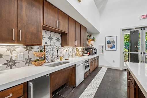 A kitchen with a white counter top and brown cabinets.