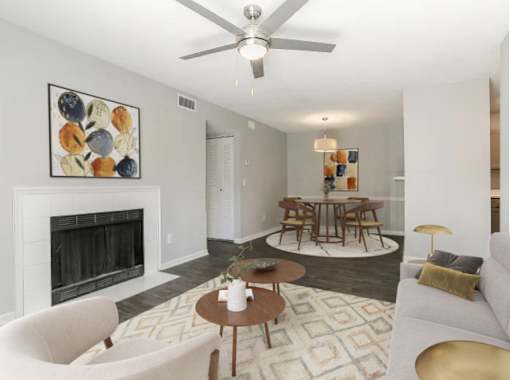 A living room with a fireplace, a dining table, and chairs.