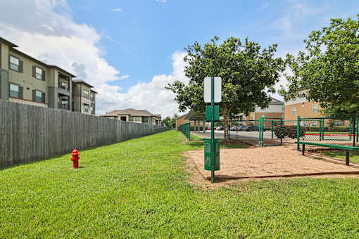 A red fire hydrant sits on a green lawn.