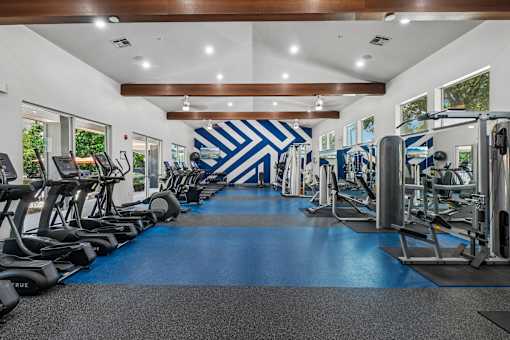 A gym with a blue and white chevron wallpaper.