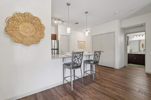 A dining room with a wooden table and chairs.