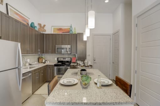 a kitchen with stainless steel appliances and a granite counter top