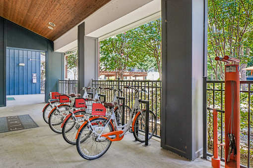 A row of bicycles are parked in a row.