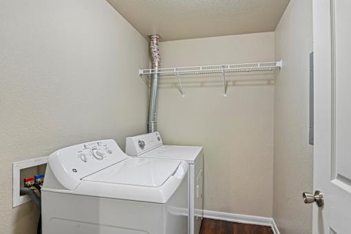A small laundry room with a washer and dryer.