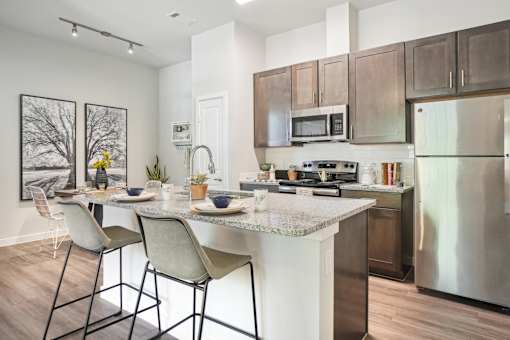 A kitchen with a table and chairs in front of a stove.