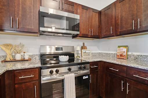 A kitchen with a stove and cabinets.