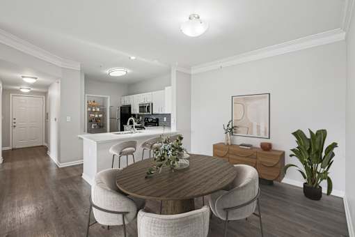 A dining room with a wooden table and chairs.