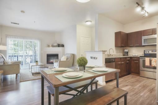 a living room with a dining room table and a kitchen