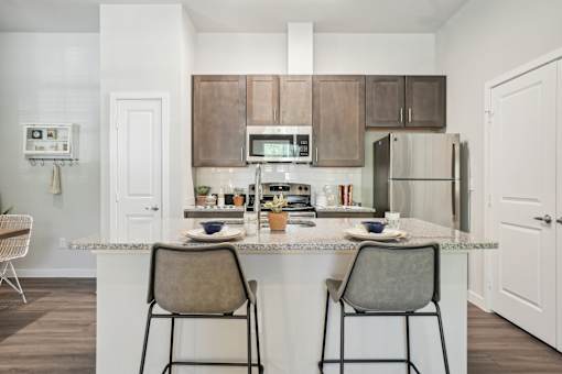 A kitchen with a white countertop and brown cabinets.
