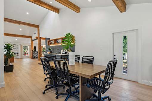 A conference room with a long table and chairs.