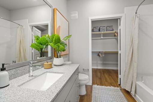 A bathroom with a white sink and a white toilet.