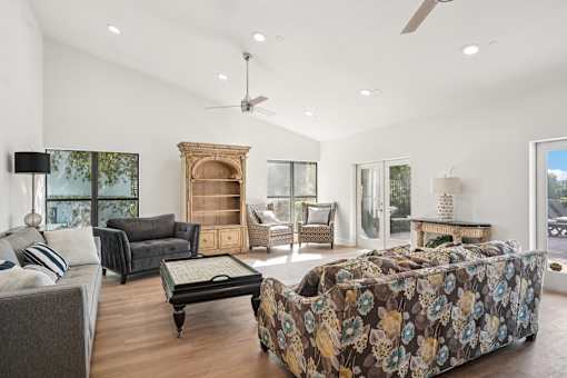 A bedroom with a large bed and a couch.