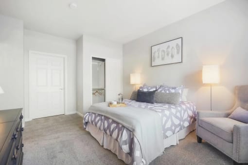 a bedroom with a bed and a chair