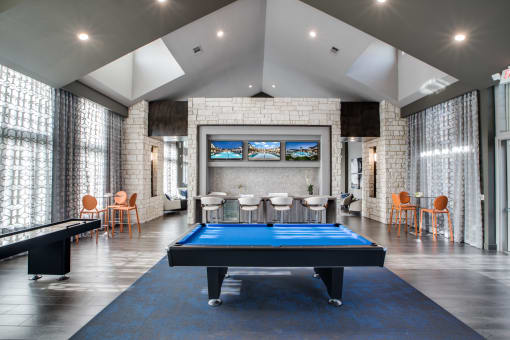 a games room with a pool table and a foosball table
