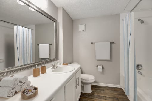 a bathroom with a toilet sink and shower