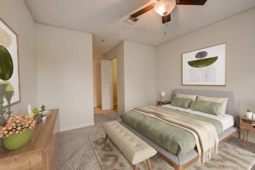 a bedroom with a large bed and a ceiling fan