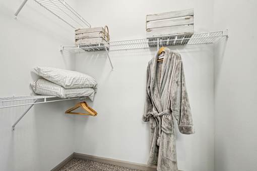 A bathroom with a robe hanging on a rack.