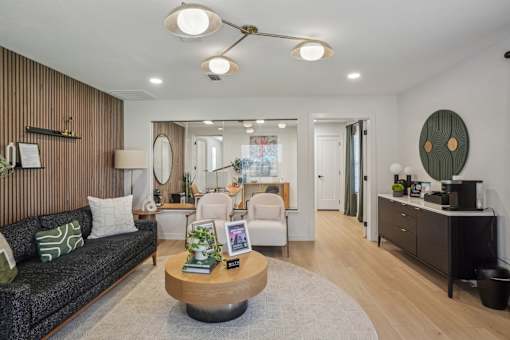 A modern living room with a grey sofa and a wooden coffee table.