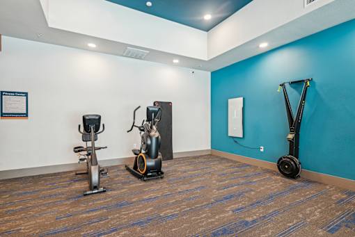 A gym with a blue wall and a wooden floor.