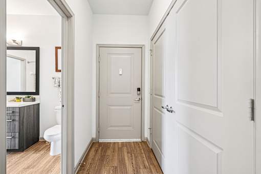 A white door is in the middle of a hallway.