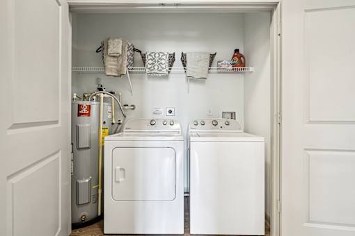 A small laundry room with a washer and dryer.