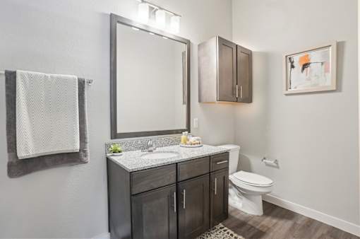 A bathroom with a white towel hanging on the wall.