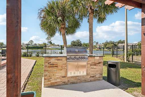 A brick oven is in the middle of a concrete slab.