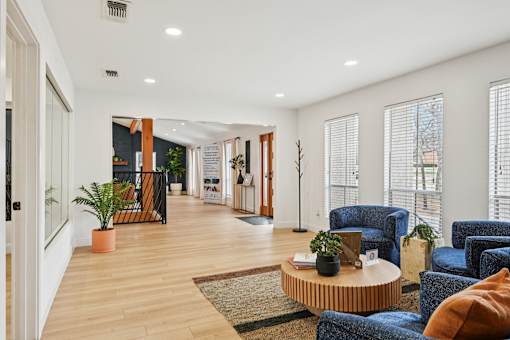 A living room with blue chairs and a coffee table.