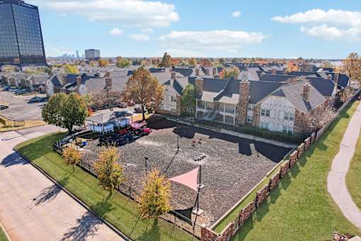 A view of a residential area with houses and a parking lot.
