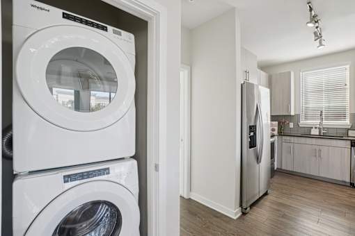 An in-unit white Whirlpool washing machine and dryer set.