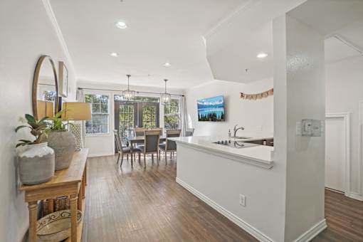 A kitchen with a dining table and chairs.