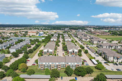 A bird's eye view of a residential area with houses and apartment buildings.