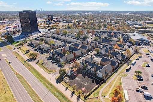 A large building stands out in the distance behind a residential area.