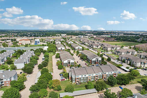 A bird's eye view of a residential area with houses and trees.