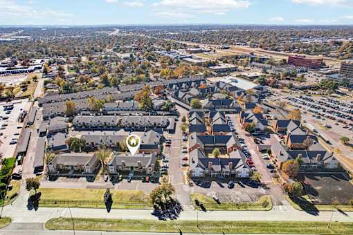A bird's eye view of a residential area with a marker indicating a specific house.