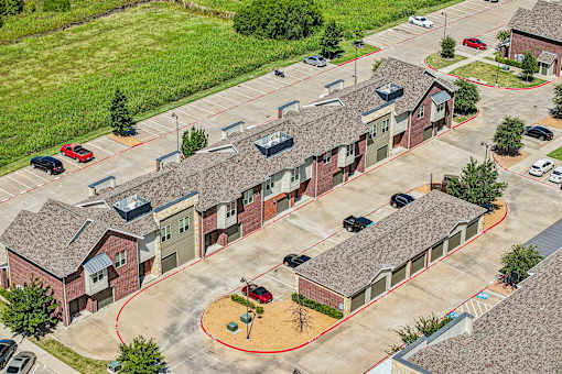A red circle is drawn around a playground area in a parking lot.
