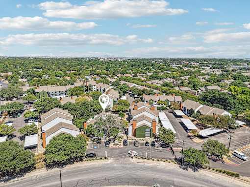 A bird's eye view of a residential area with a church in the center.
