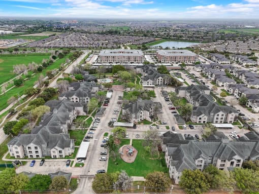 an aerial view of a neighborhood with houses and a lake