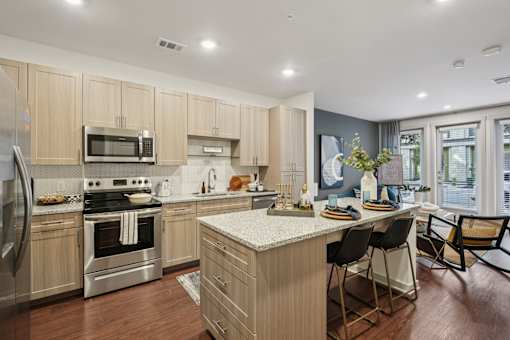 A modern kitchen with wooden cabinets and stainless steel appliances.