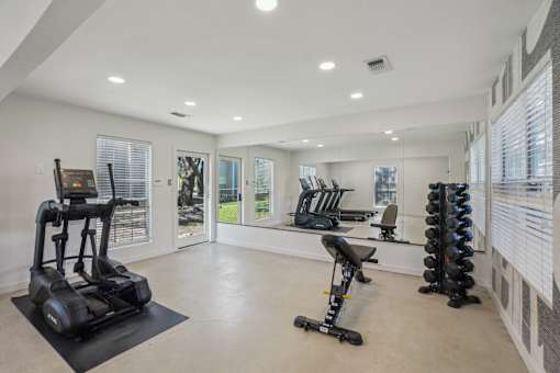 A spacious home gym with a variety of exercise equipment.