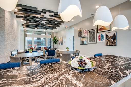 Clubroom view from island counter showing dining tables and lounge seating.