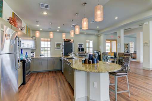 A kitchen with a large island and a refrigerator.