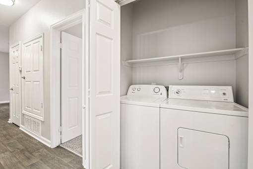A white laundry room with a washer and dryer.