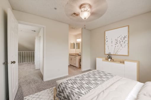 an open bedroom and bathroom with a bed and a closet