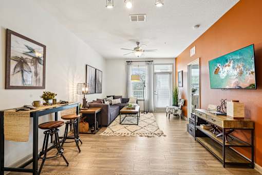 A living room with a bar area and a couch.