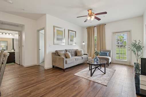 A living room with a brown sofa and a coffee table.