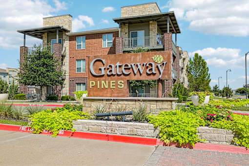The image shows a building with a sign that reads "Gateway Pines".
