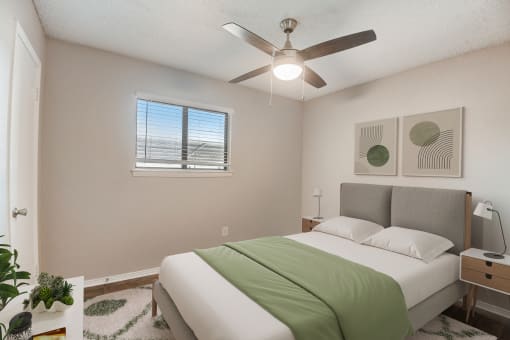 a bedroom with a bed and a ceiling fan